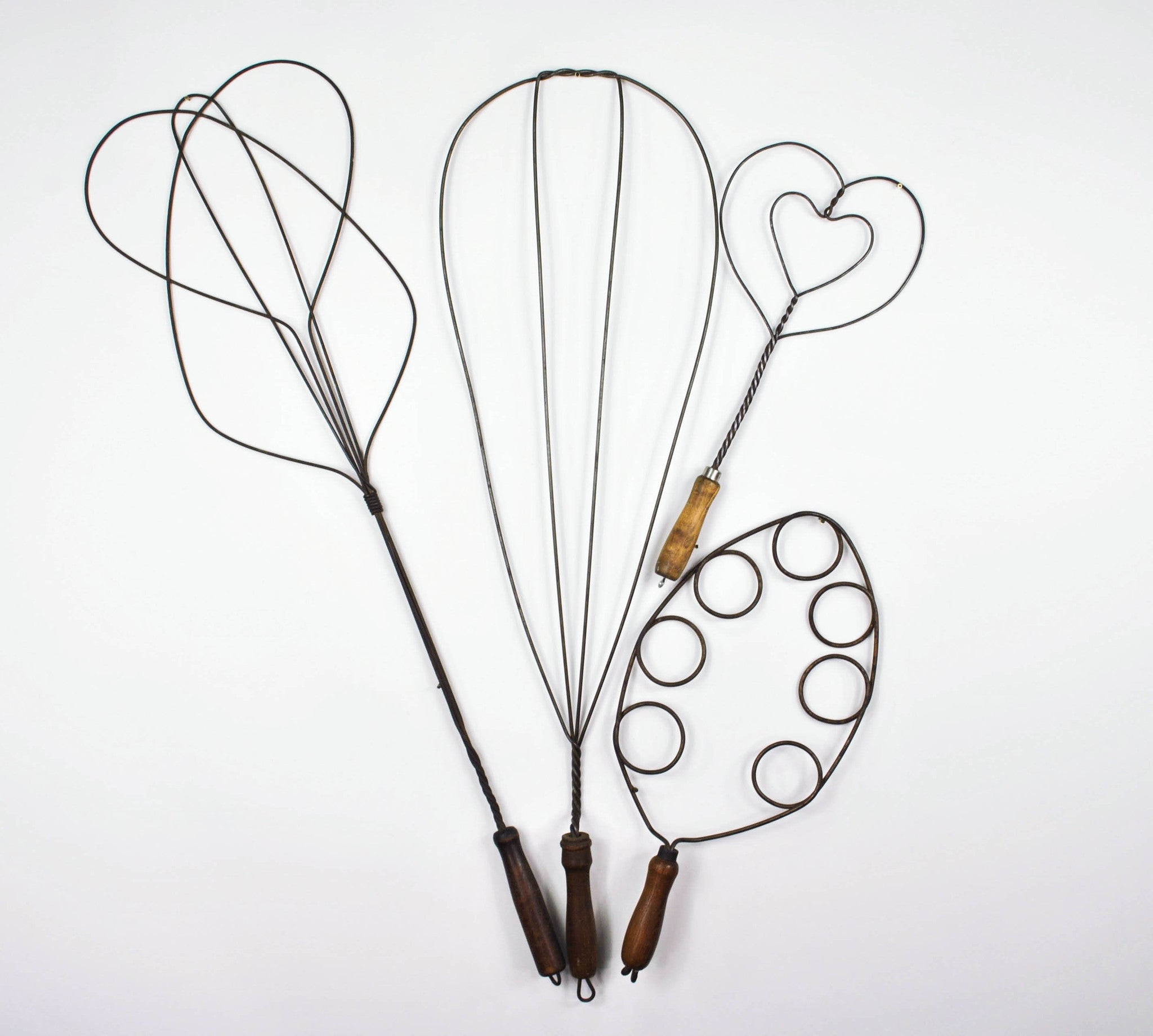 Four Antique 1900s Wire Rug Beaters with Trivet Heart Design and Wood Handles